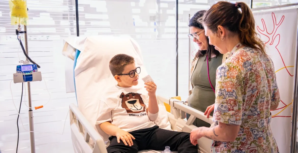A patient participating in a clinical trial with a family member and healthcare staff. A patient participating in a clinical trial with a family member and healthcare staff.