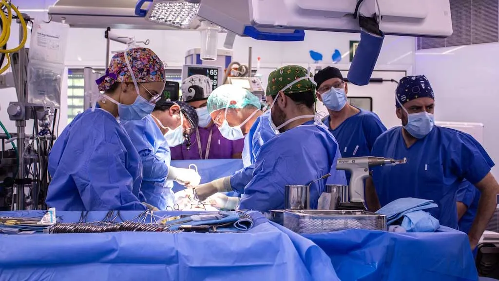SJD surgical team during the operation on an infant with a double pathology SJD surgical team during the operation on an infant with a double pathology