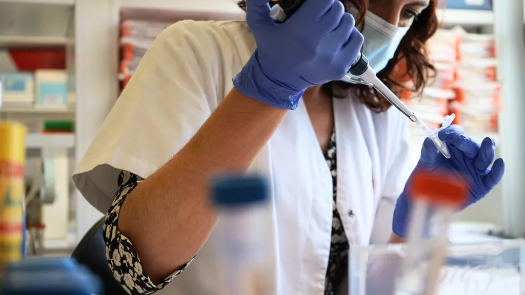 A professional processes a sample in the molecular diagnostic laboratory A professional processes a sample in the molecular diagnostic laboratory