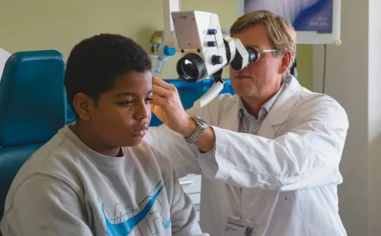 Dr. Oliver Haag examining his patient Aissam Dr. Oliver Haag examining his patient Aissam
