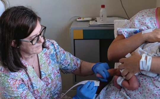 Performing a heel prick test on a newborn Performing a heel prick test on a newborn