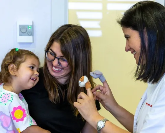 Dr Carme Fons in a neurology consultation with a patient and their mother Dr Carme Fons in a neurology consultation with a patient and their mother