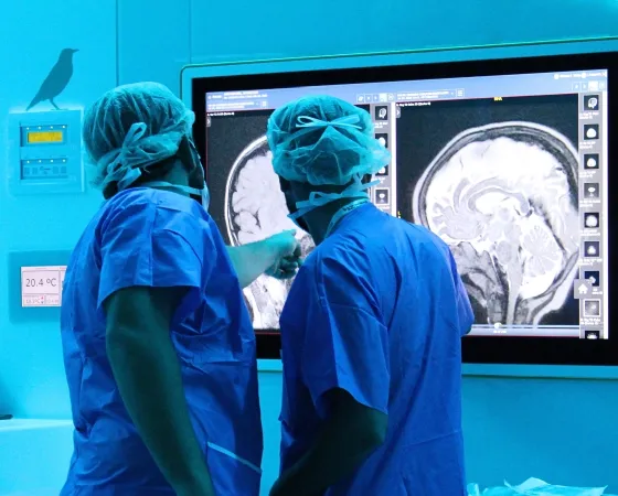 Surgeons examining a brain radiography image during an operation - SJD Barcelona Children's Hospital Surgeons examining a brain radiography image during an operation - SJD Barcelona Children's Hospital