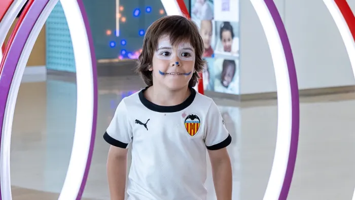 Child with his face painted playing in the lobby of the SJD Barcelona Children's Hospital. Child with his face painted playing in the lobby of the SJD Barcelona Children's Hospital.